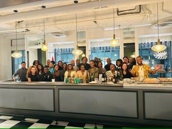 ADW Collective members gathered together at a daytime workplace event.